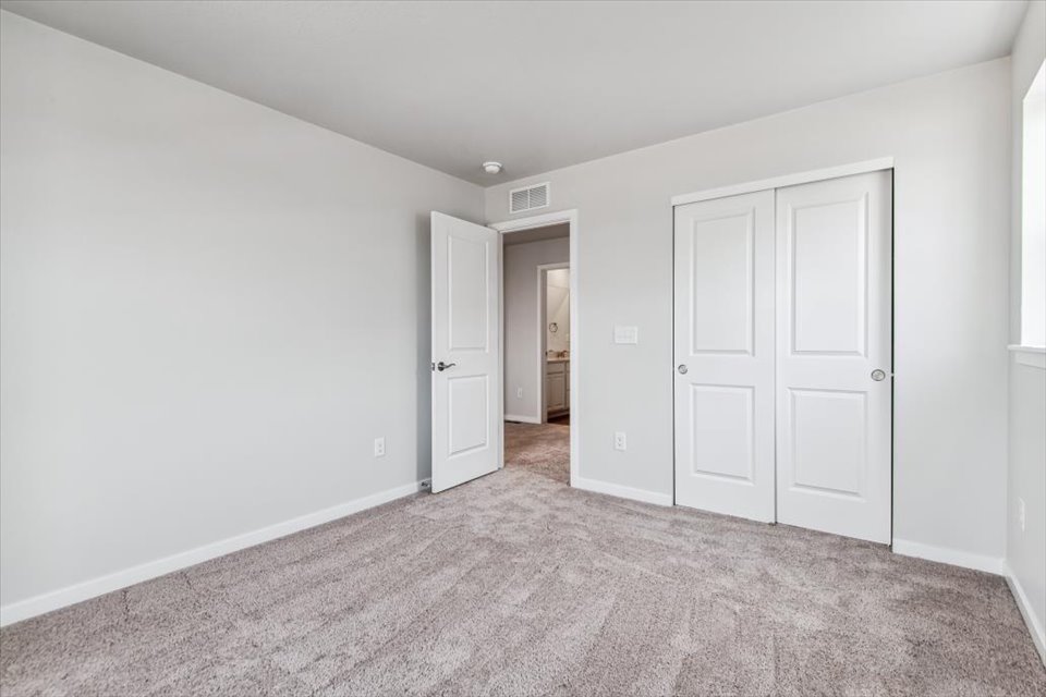 A hallway with white doors.