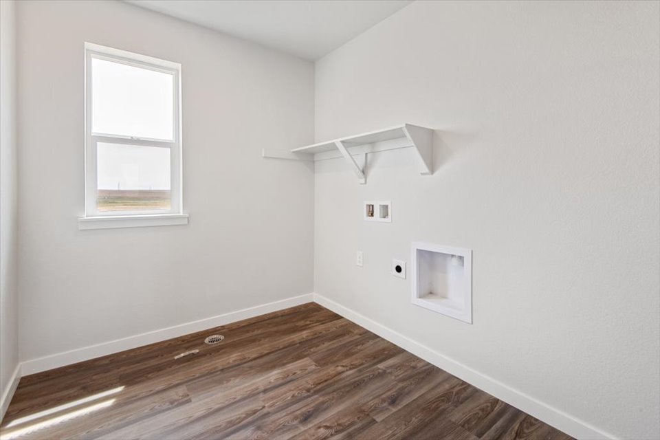 A room with a wood floor and a wood floor with a window.