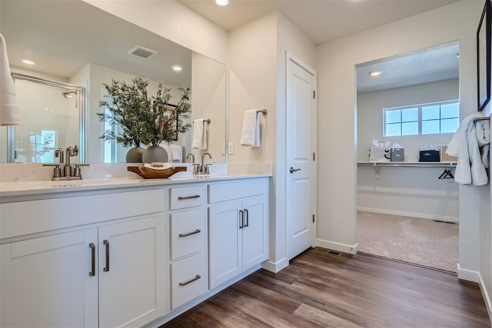 A bathroom with white cabinets.