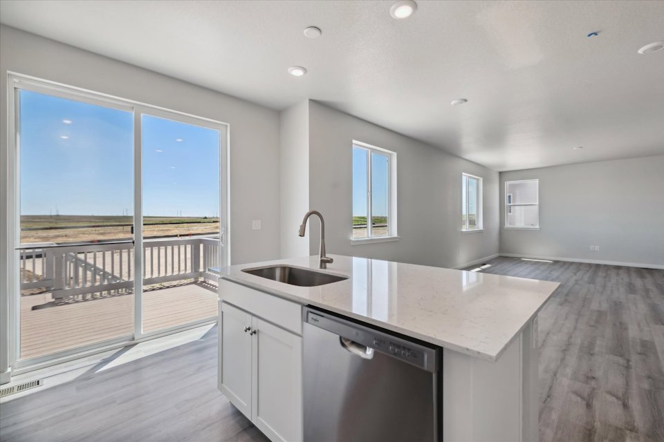 A kitchen with a large window.