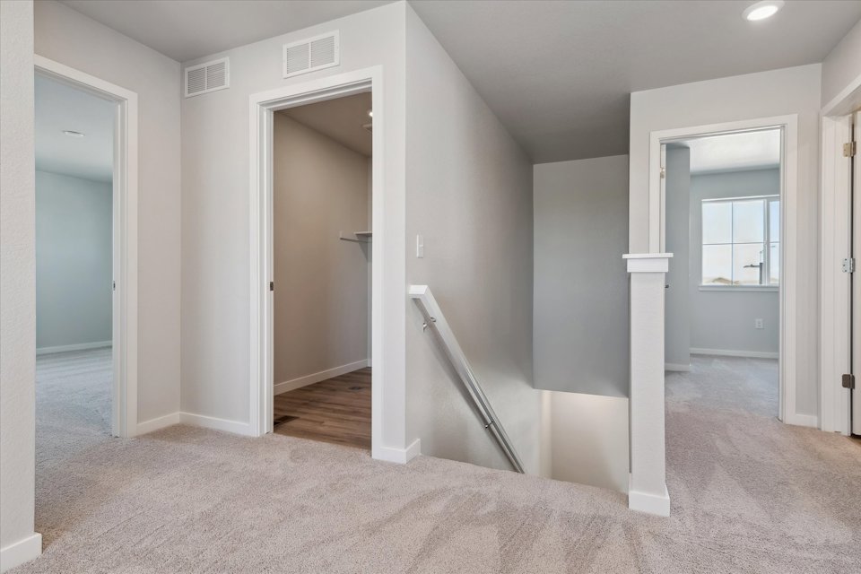 A room with a staircase and a door.