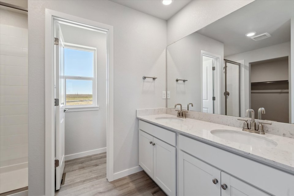 A bathroom with a large mirror.