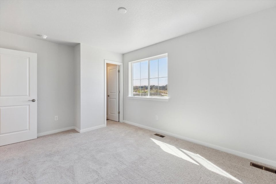 A room with a window and a door.