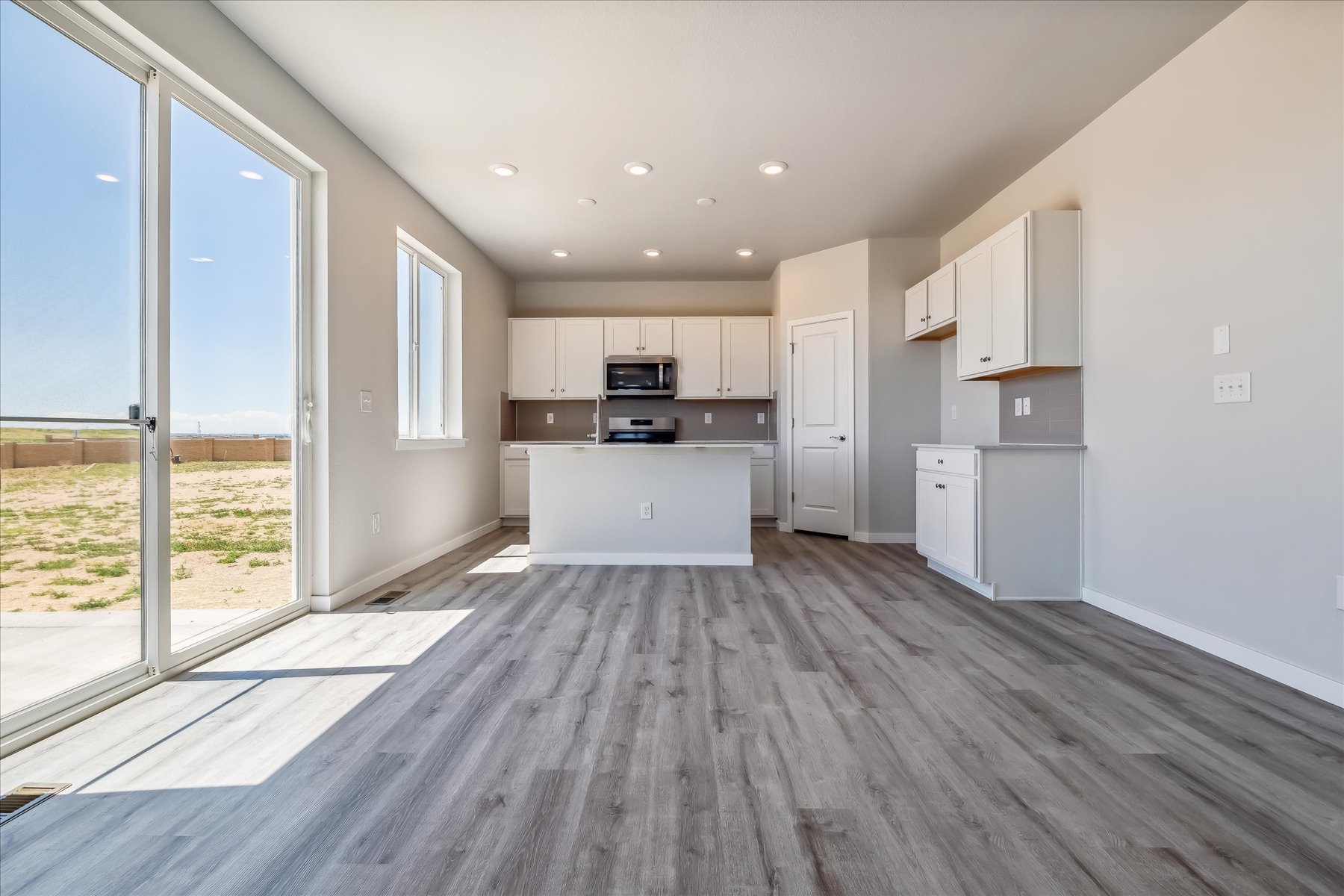 A kitchen with a wood floor.