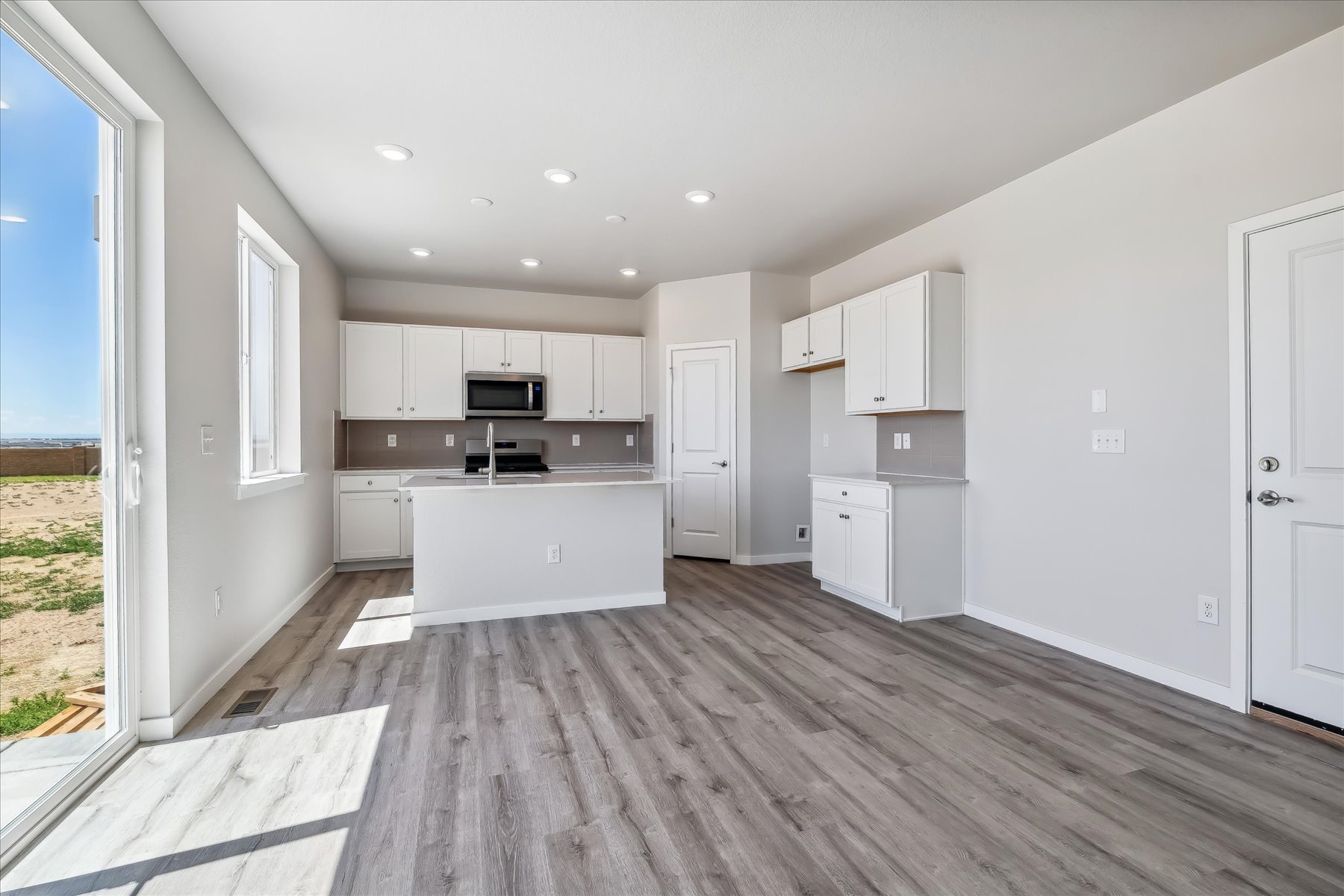 A kitchen with white cabinets.