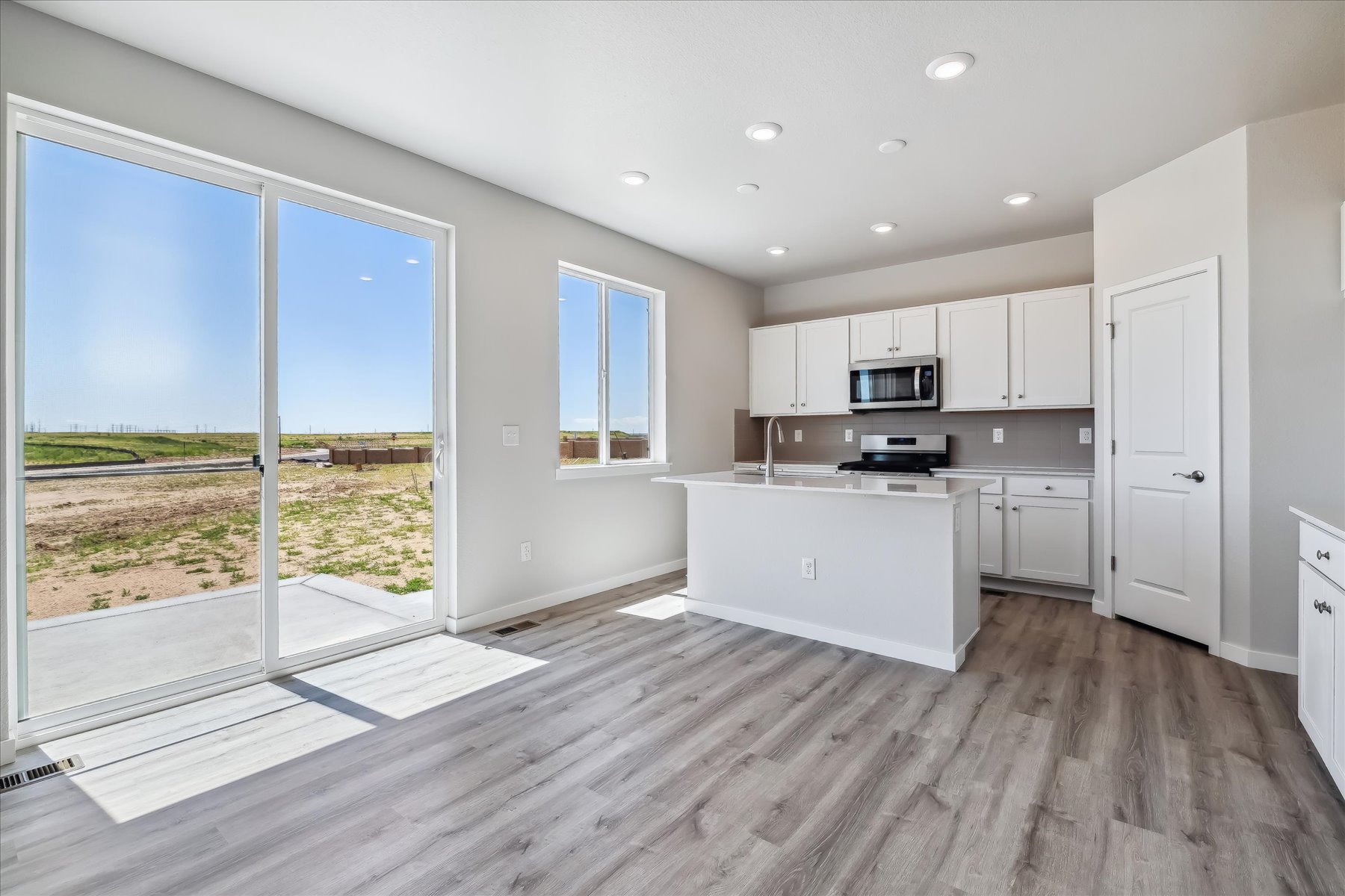 A kitchen with white cabinets.