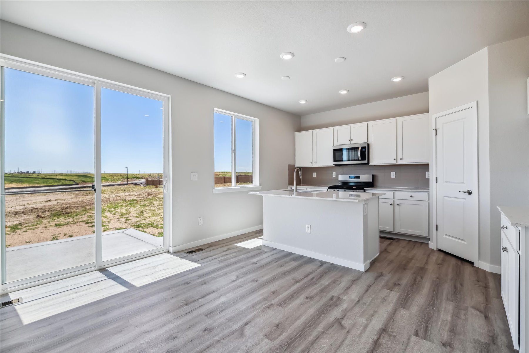 A kitchen with white cabinets.