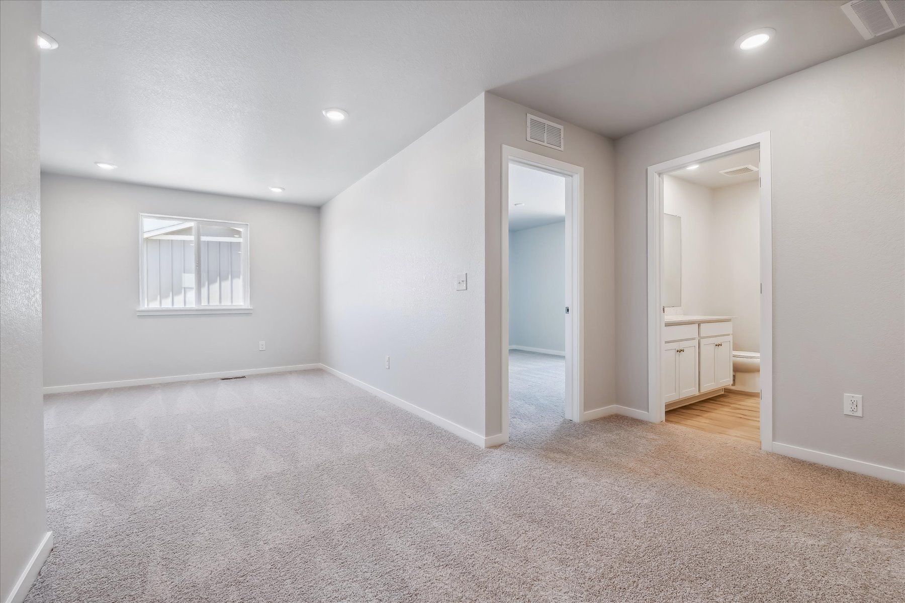 A room with a carpet and a door.