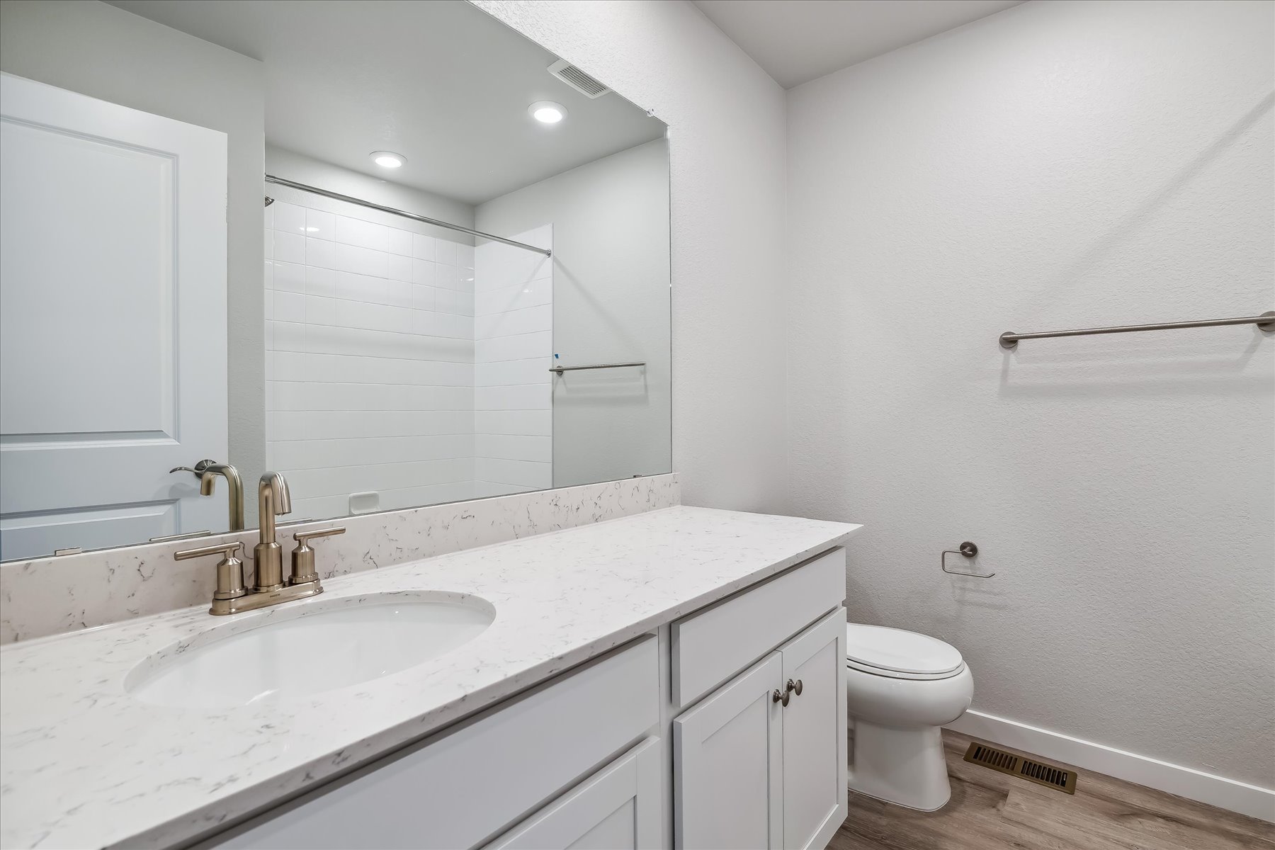 A bathroom with a large mirror.
