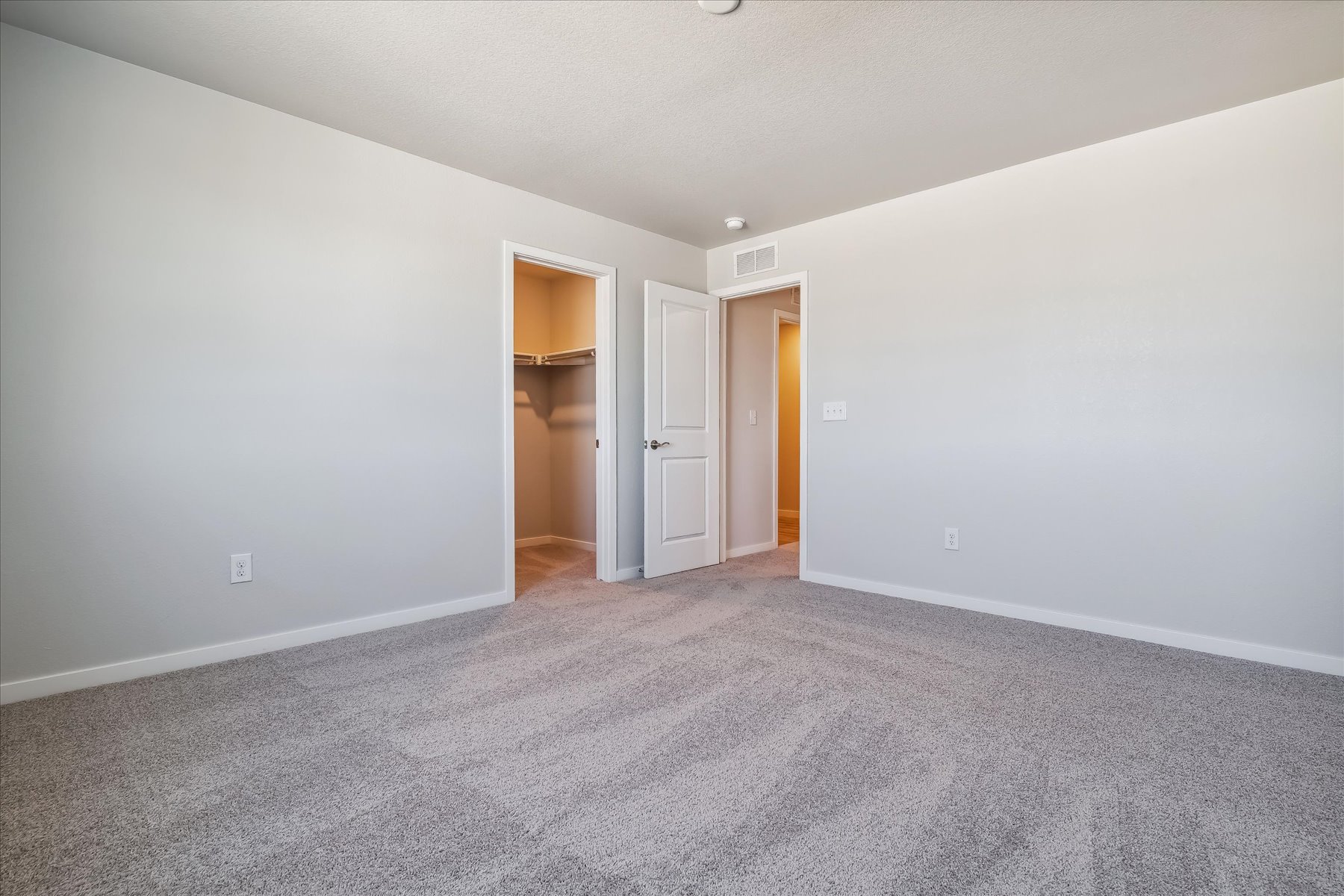 A hallway with white walls.