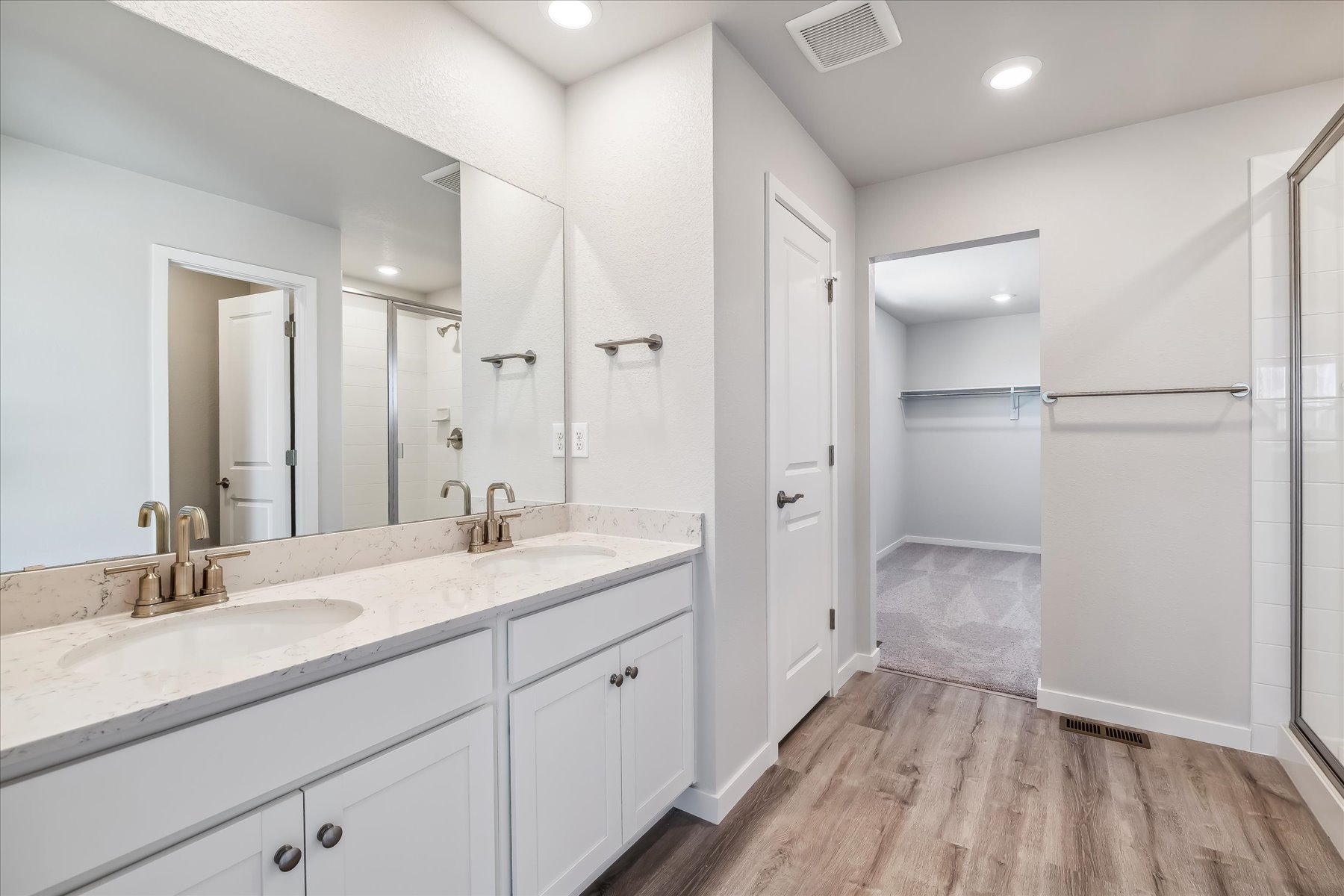 A bathroom with white cabinets.