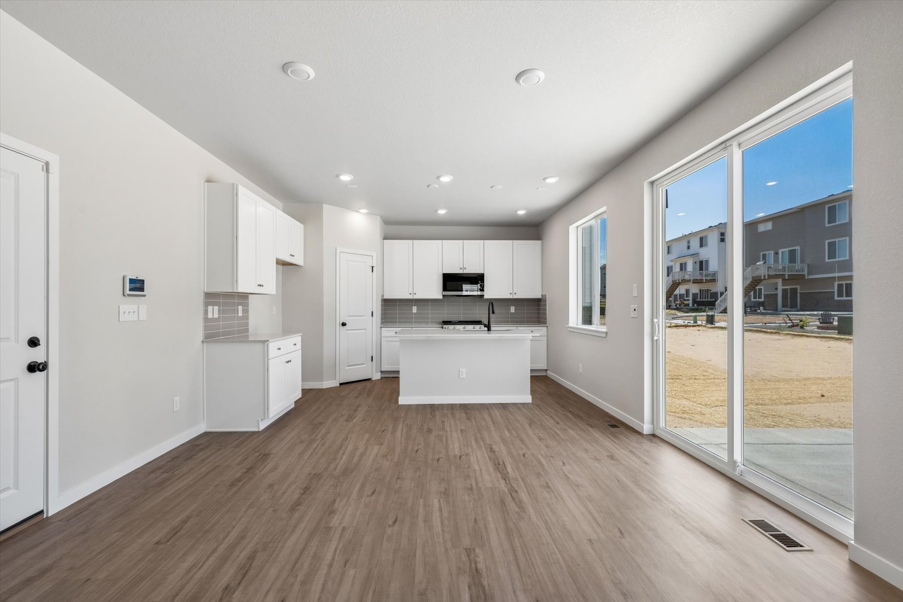 A large kitchen with white cabinets.