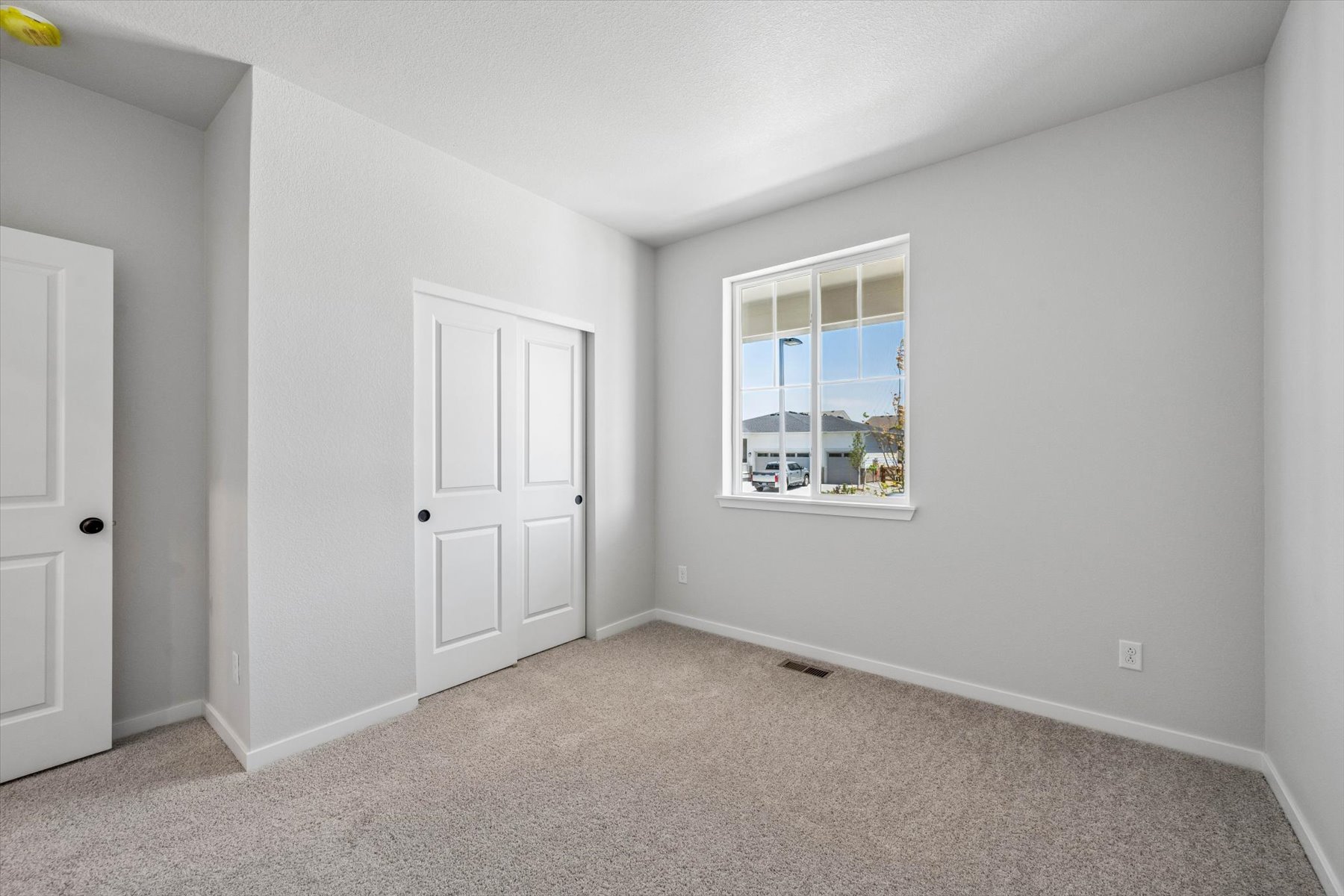 A room with white doors and a window.