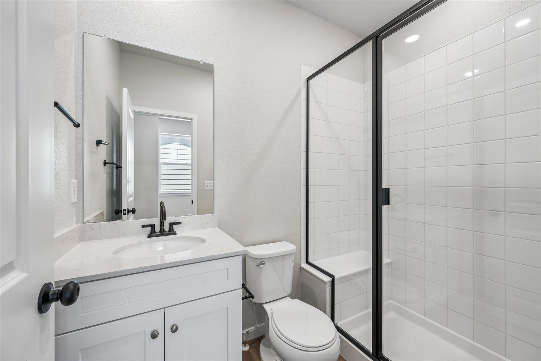 A bathroom with a glass shower.