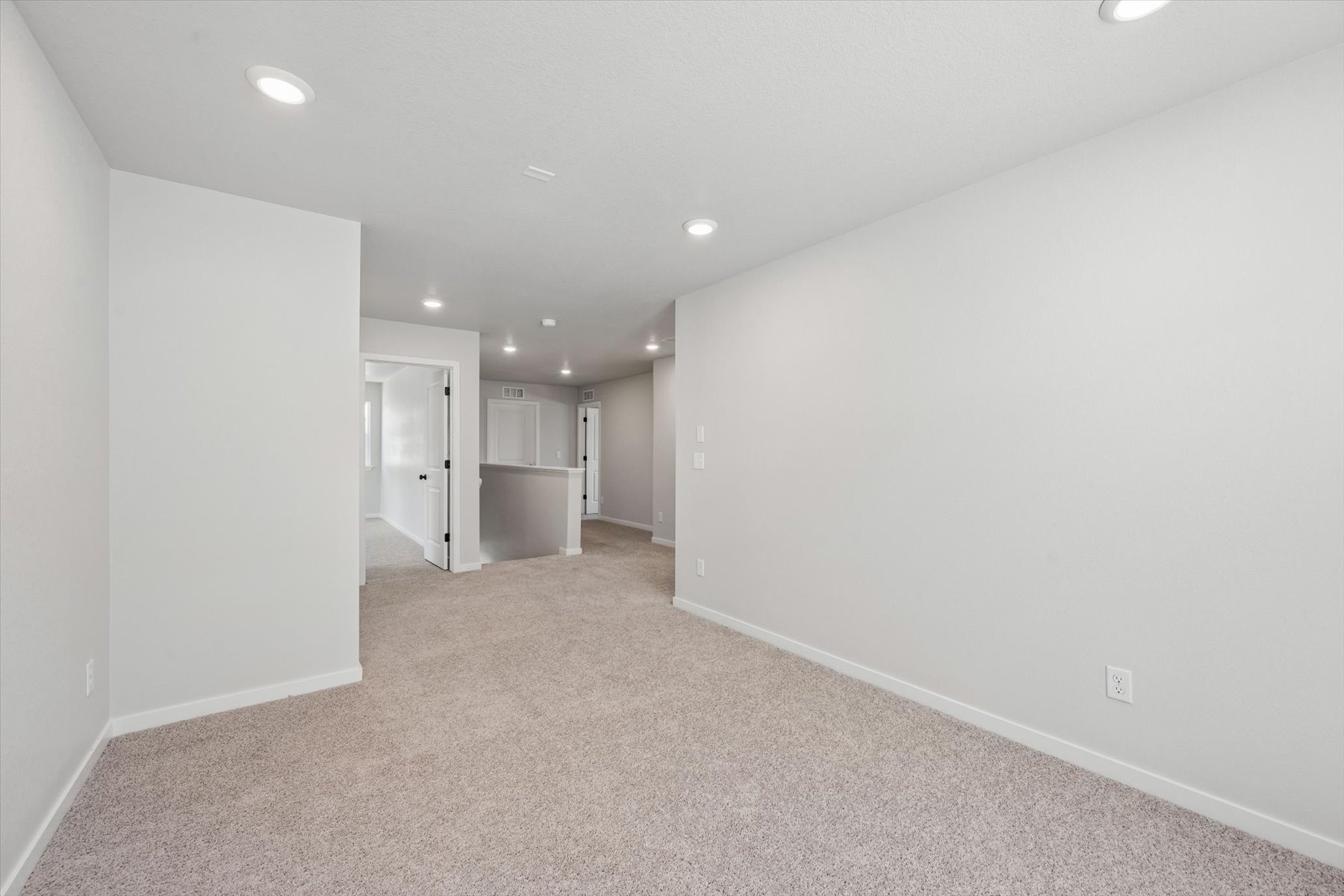 A hallway with white walls.
