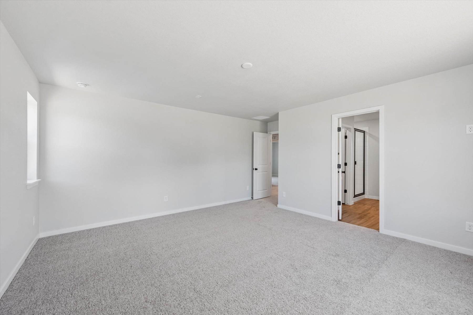 A long hallway with white walls.
