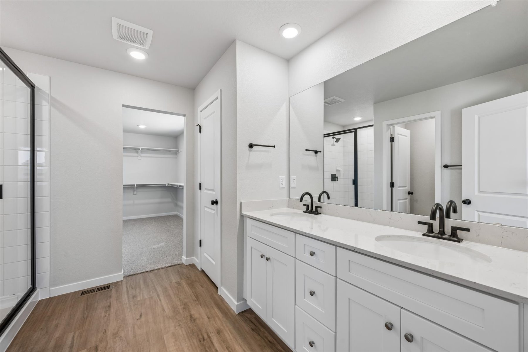 A bathroom with white cabinets.