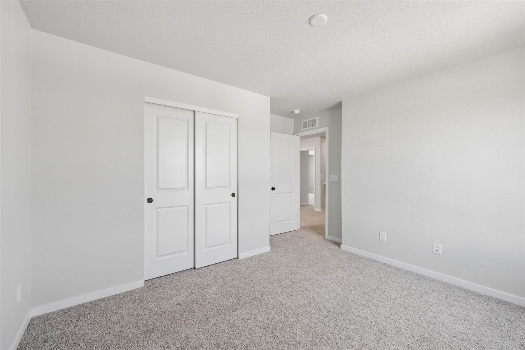 A hallway with white doors.