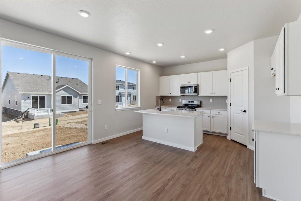 A kitchen with white cabinets.