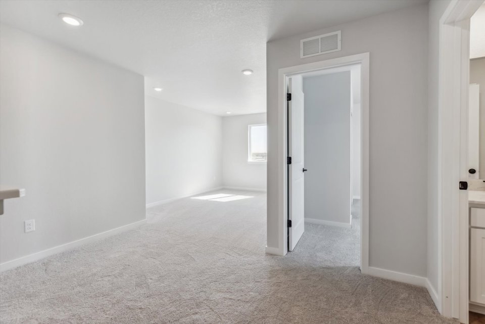 A hallway with white walls.