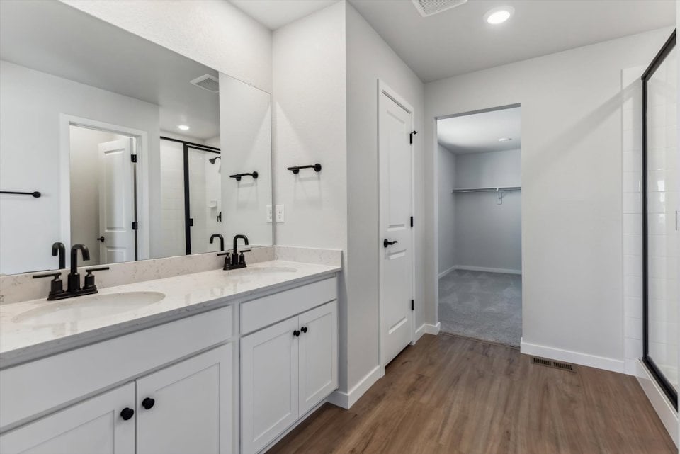 A bathroom with white cabinets.