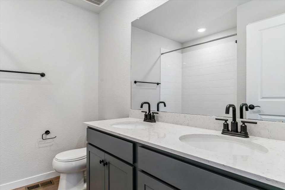 A bathroom with a large mirror.