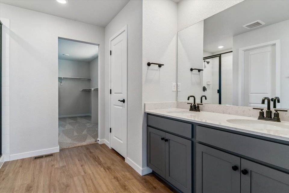 A bathroom with a large mirror.