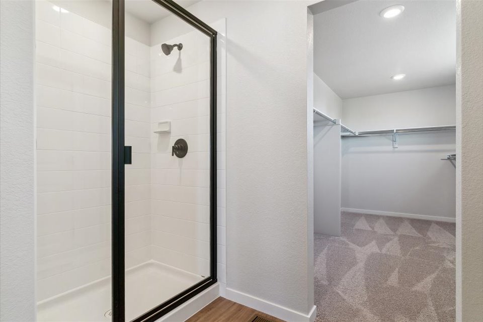 A shower with a glass door.