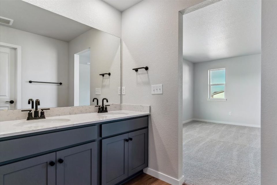 A bathroom with a large mirror.