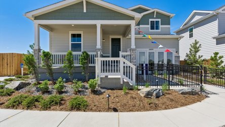 A house with a fence and bushes.