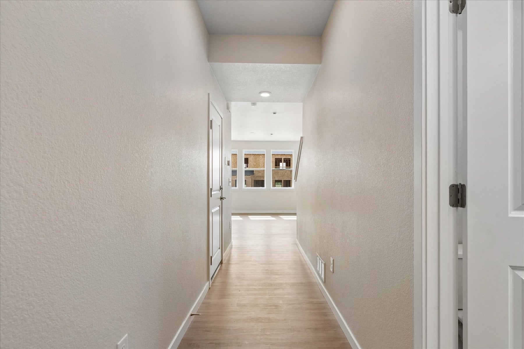 A hallway with white walls.