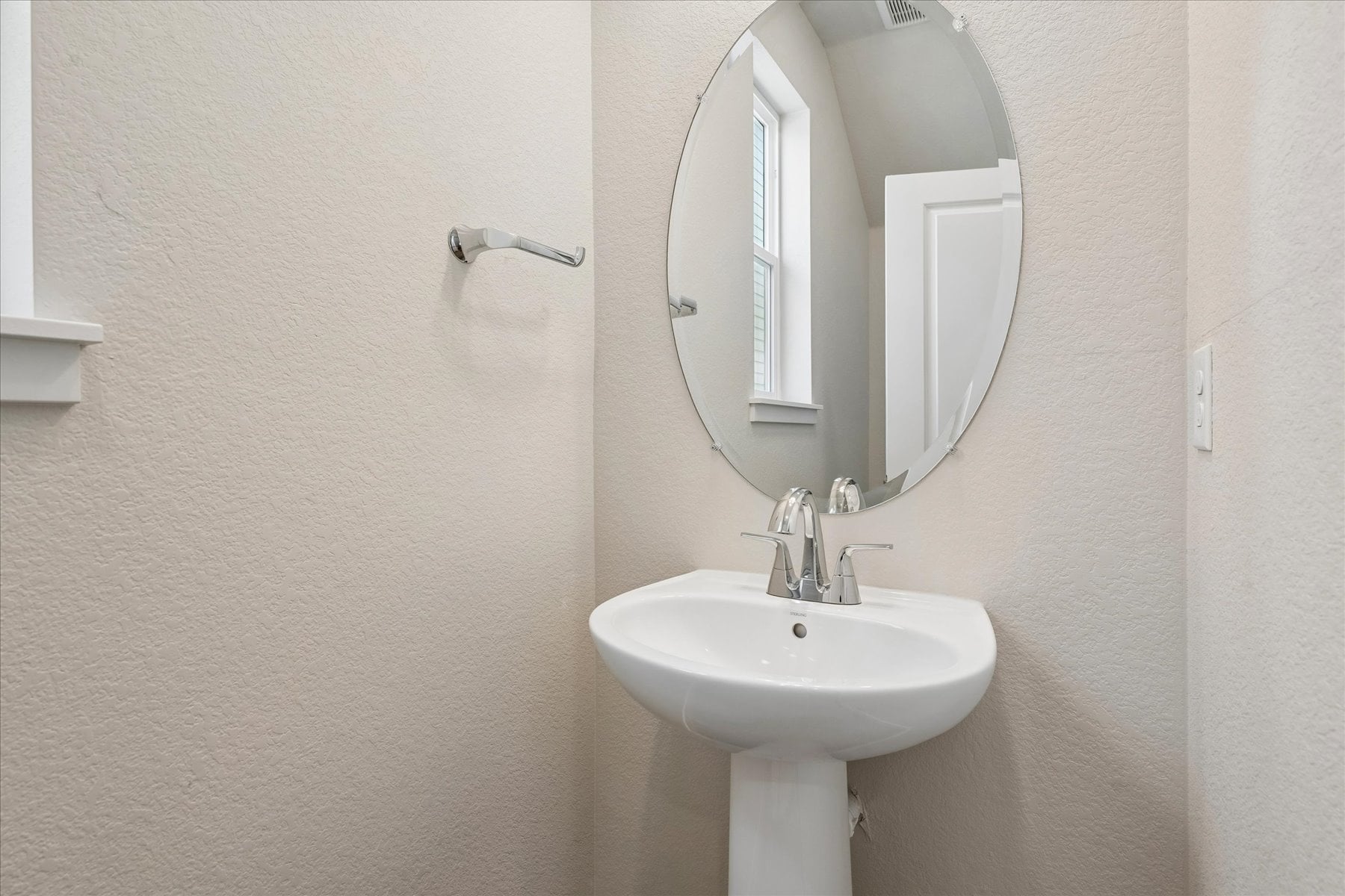 A bathroom with a mirror and sink.