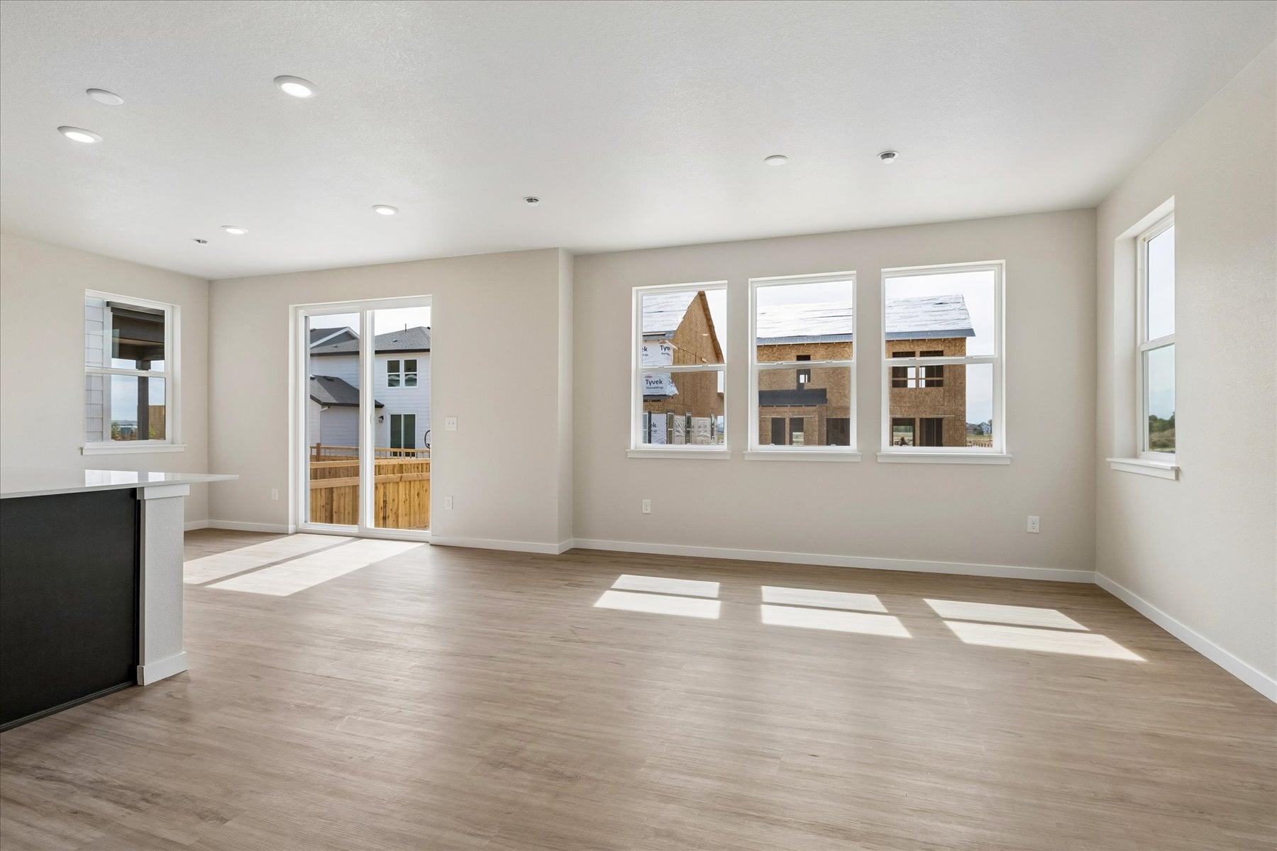 A large empty room with a wood floor and white walls.