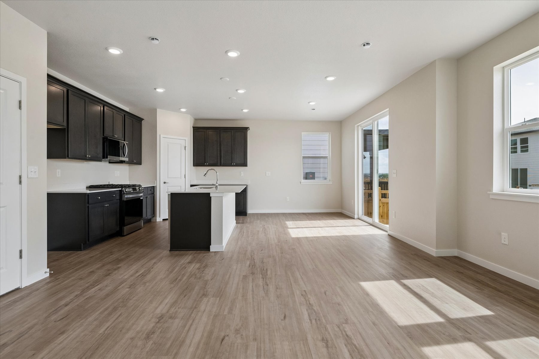 A large kitchen with black cabinets.