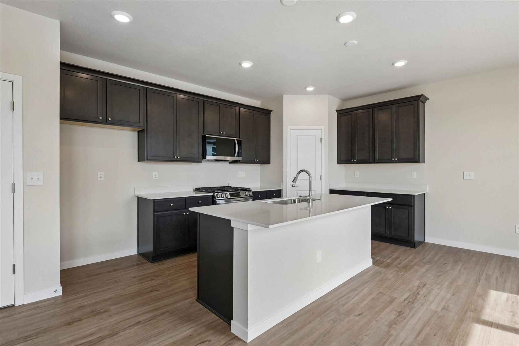 A kitchen with black cabinets.