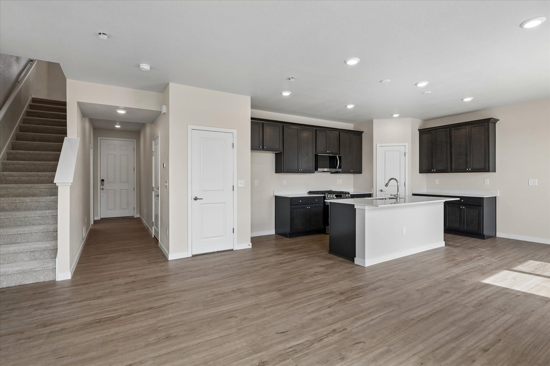 A large kitchen with black cabinets.