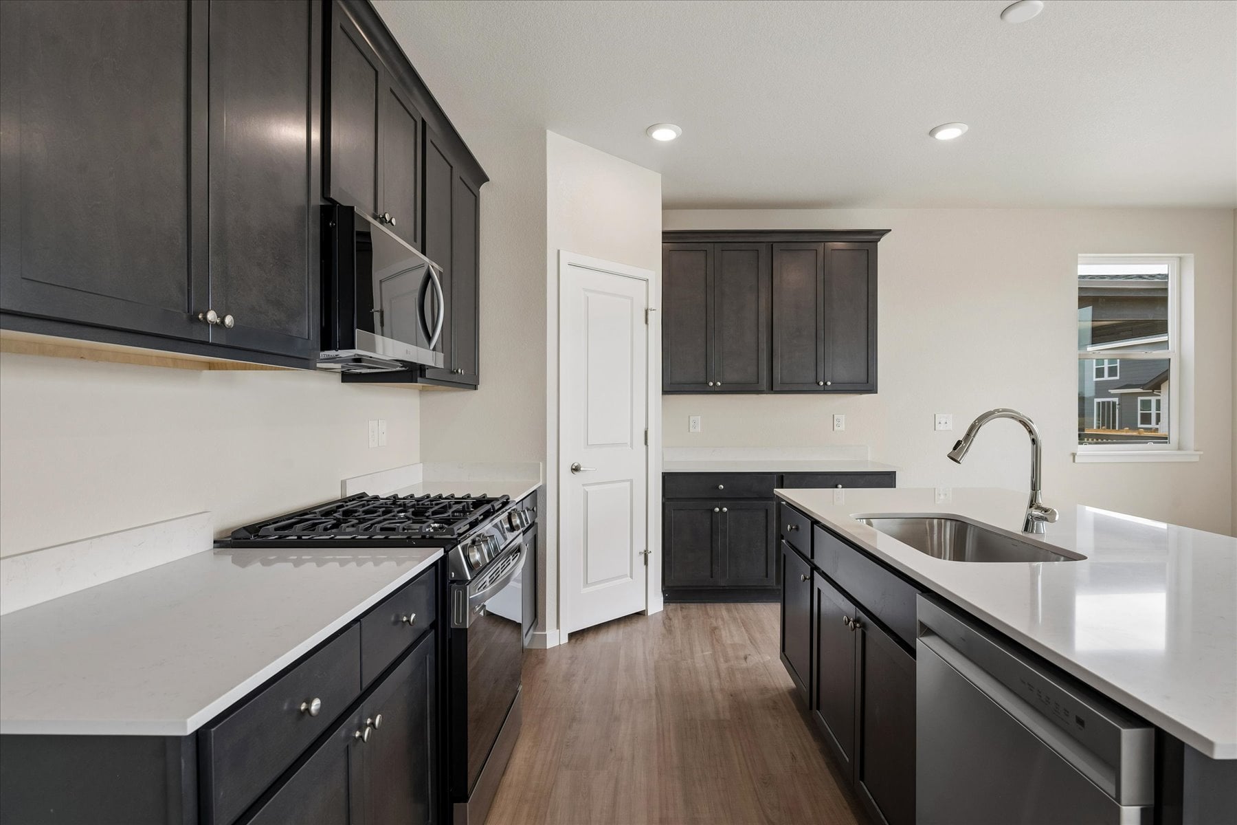 A kitchen with black cabinets.