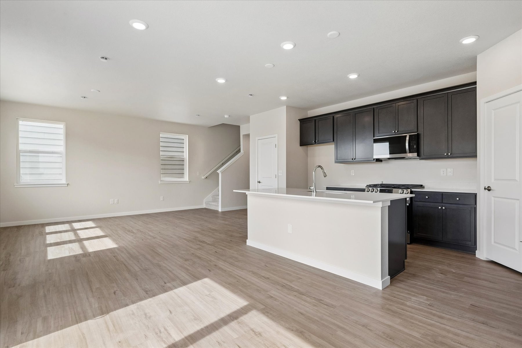 A kitchen with black cabinets.