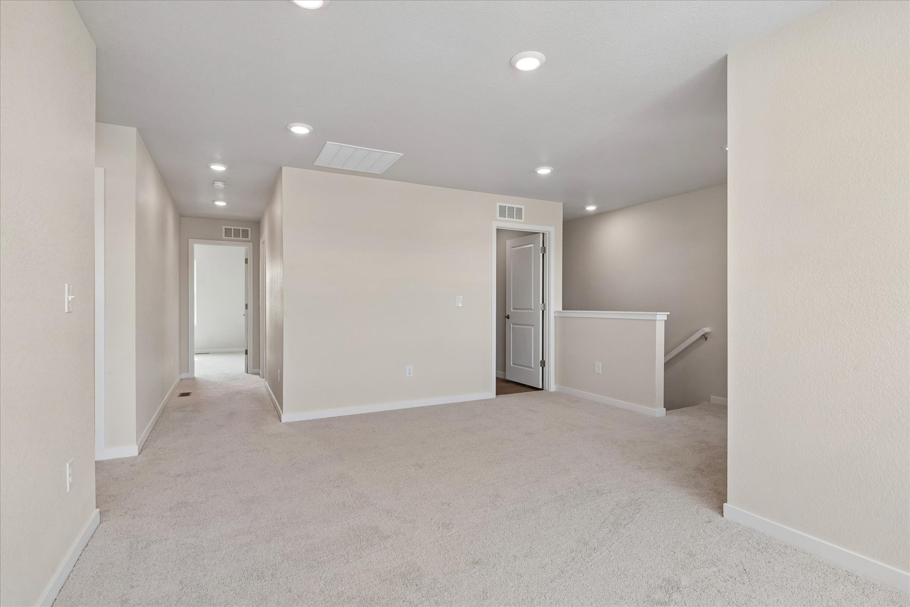 A hallway with white walls.
