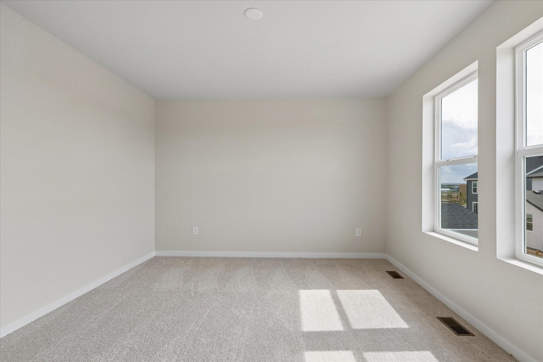 A room with a tile floor and windows.