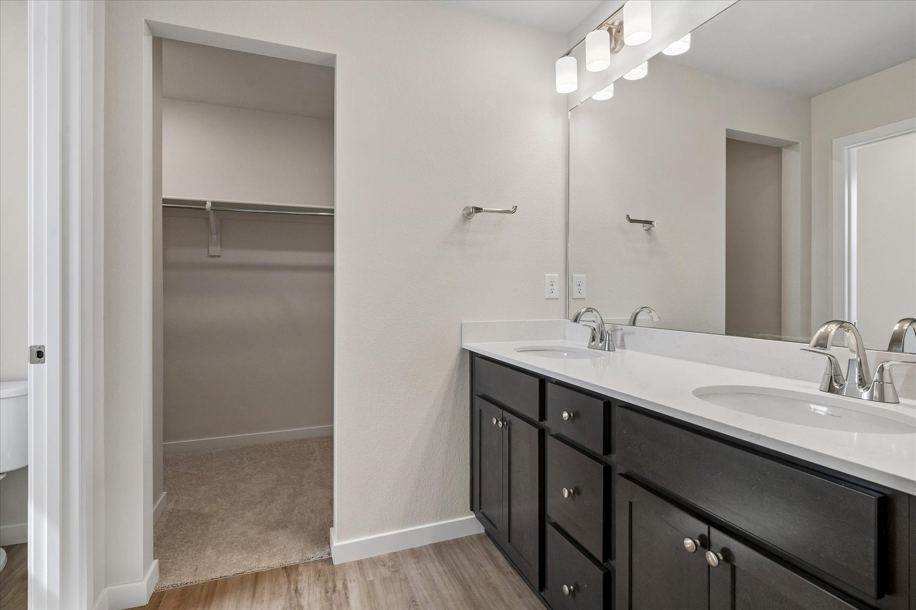 A bathroom with a shower and sink.