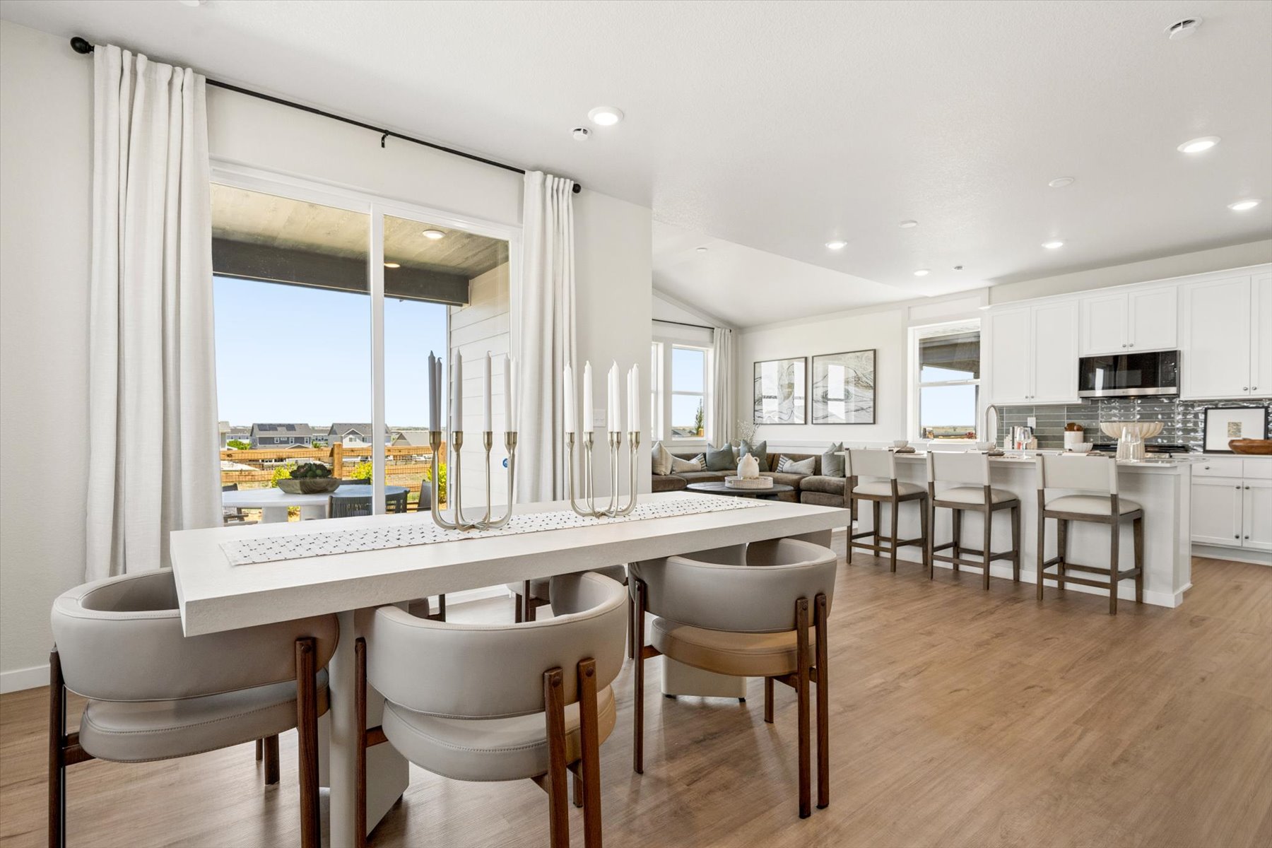A large kitchen with a large dining table and chairs.