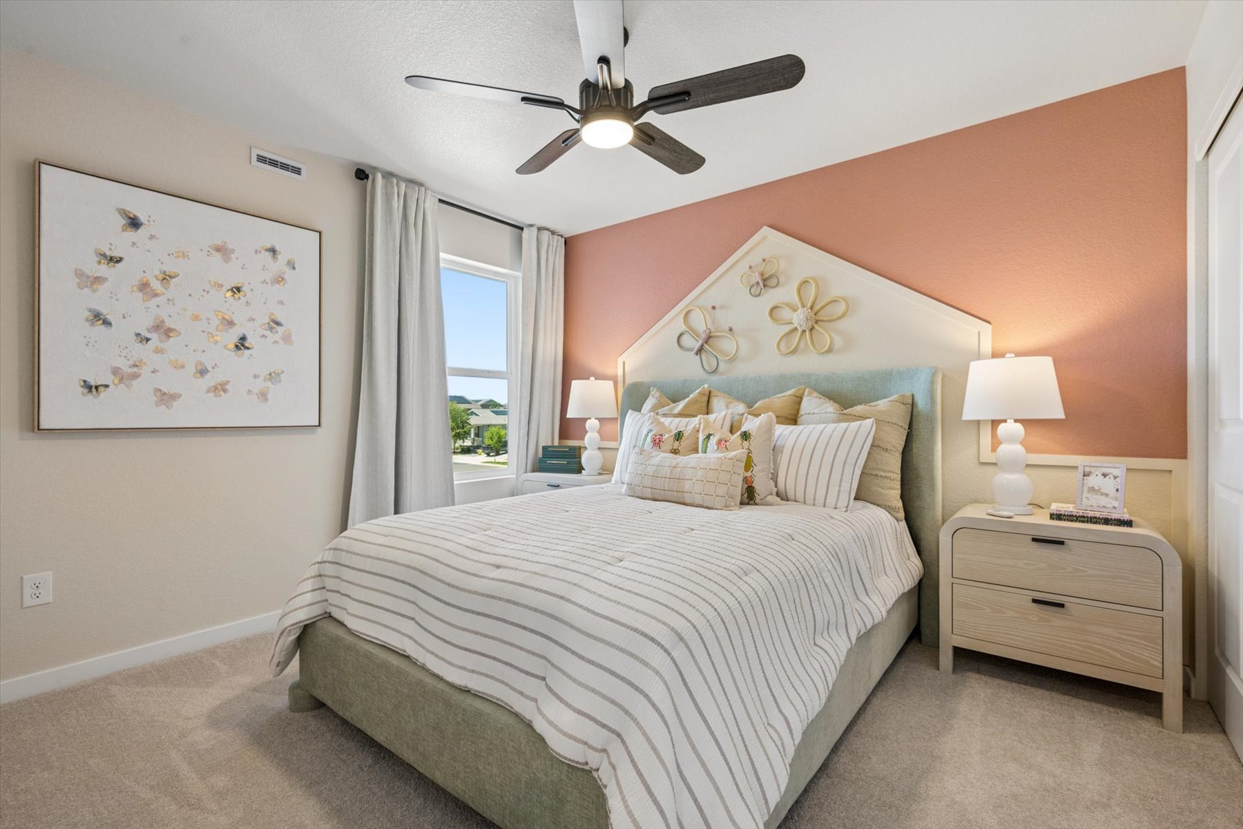 A bedroom with a bed and a fan.
