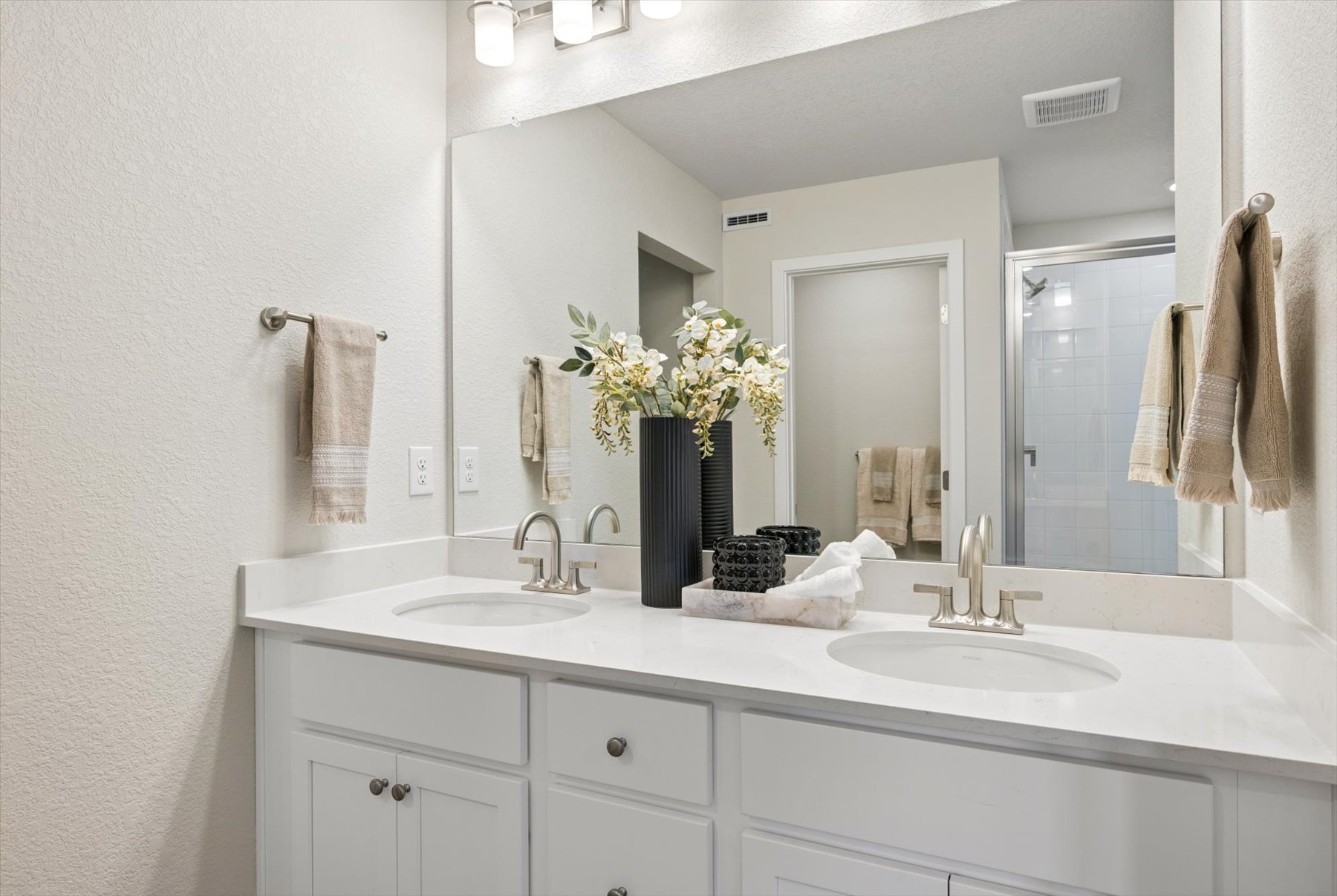 A bathroom with a large mirror.