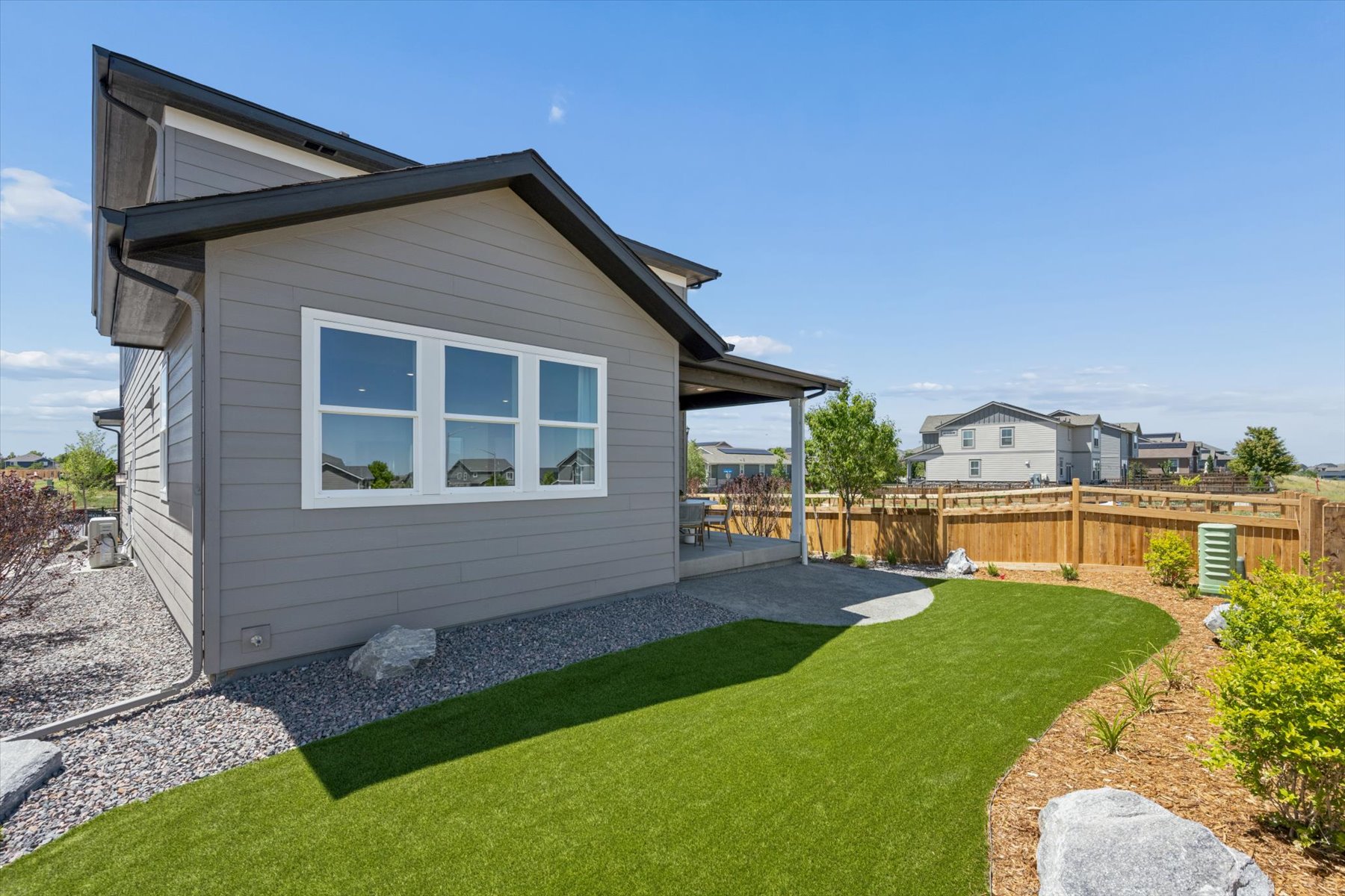 A house with a fence and grass.