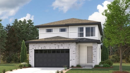 A house with a garage and trees around it.