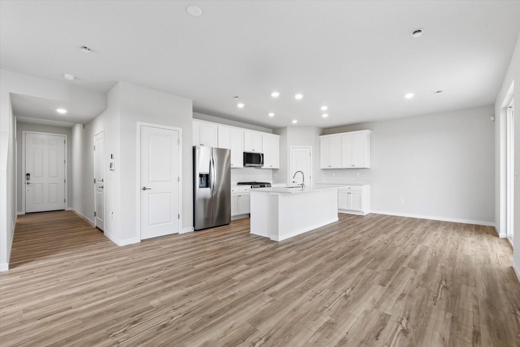 A kitchen with white cabinets.