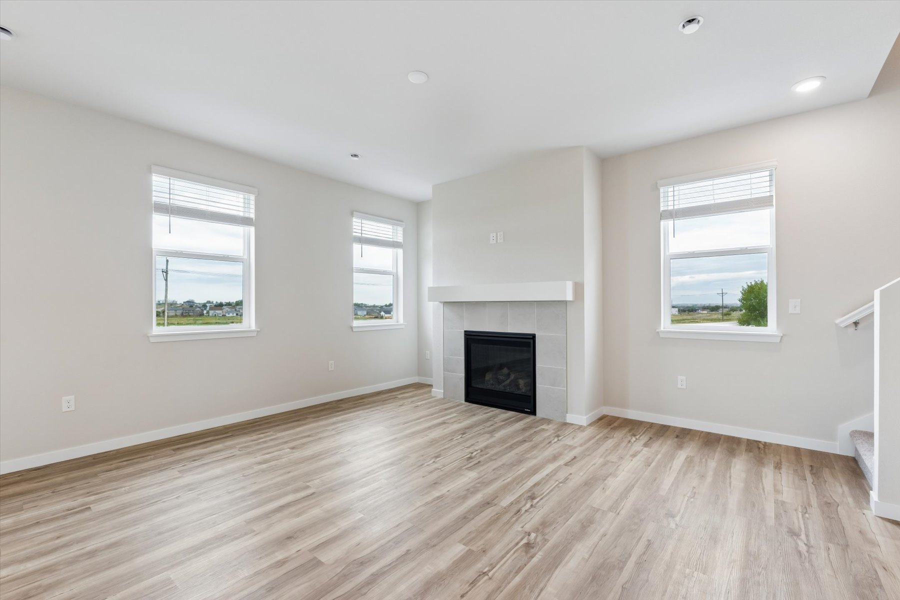 A room with a fireplace and windows.