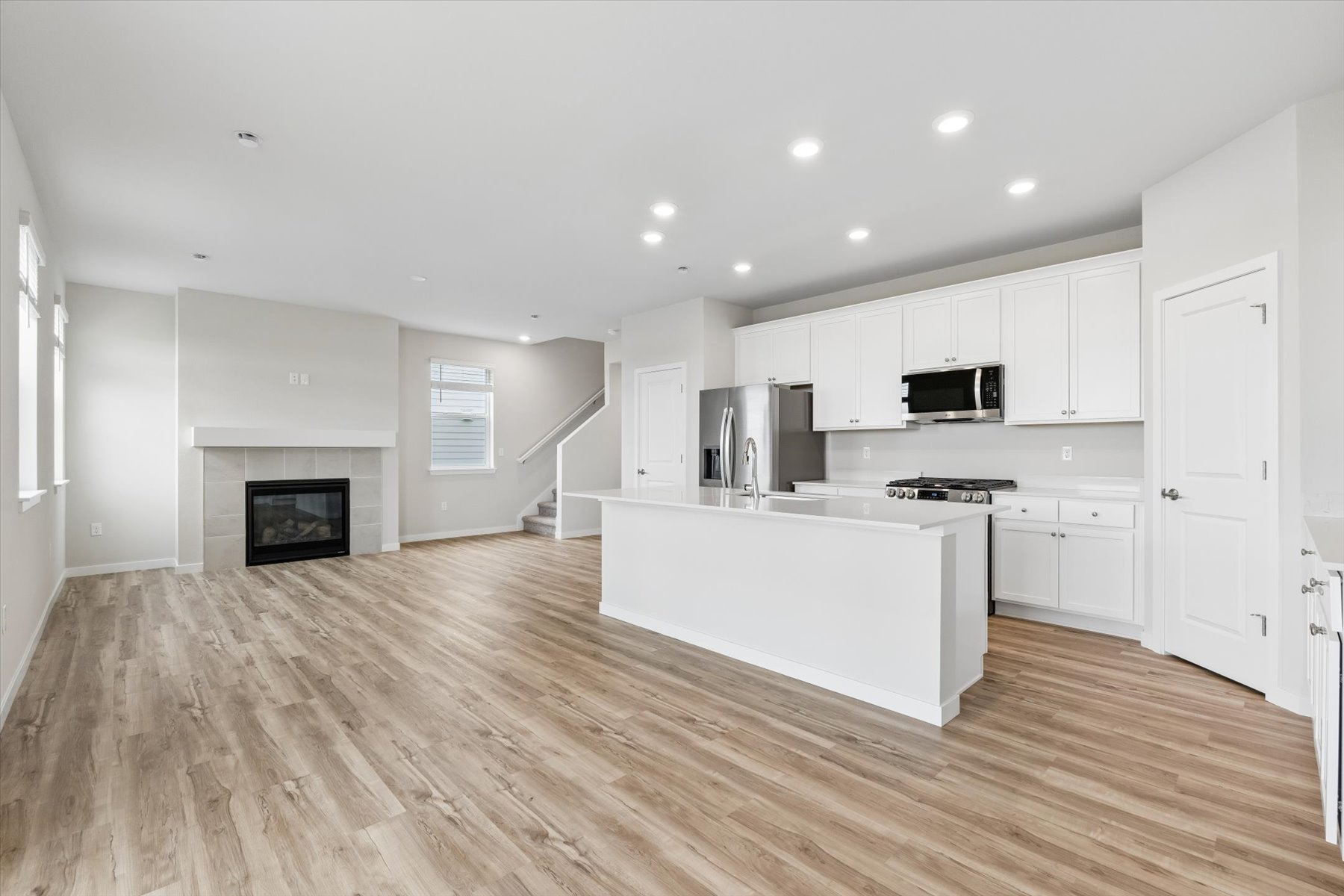 A kitchen with white cabinets.