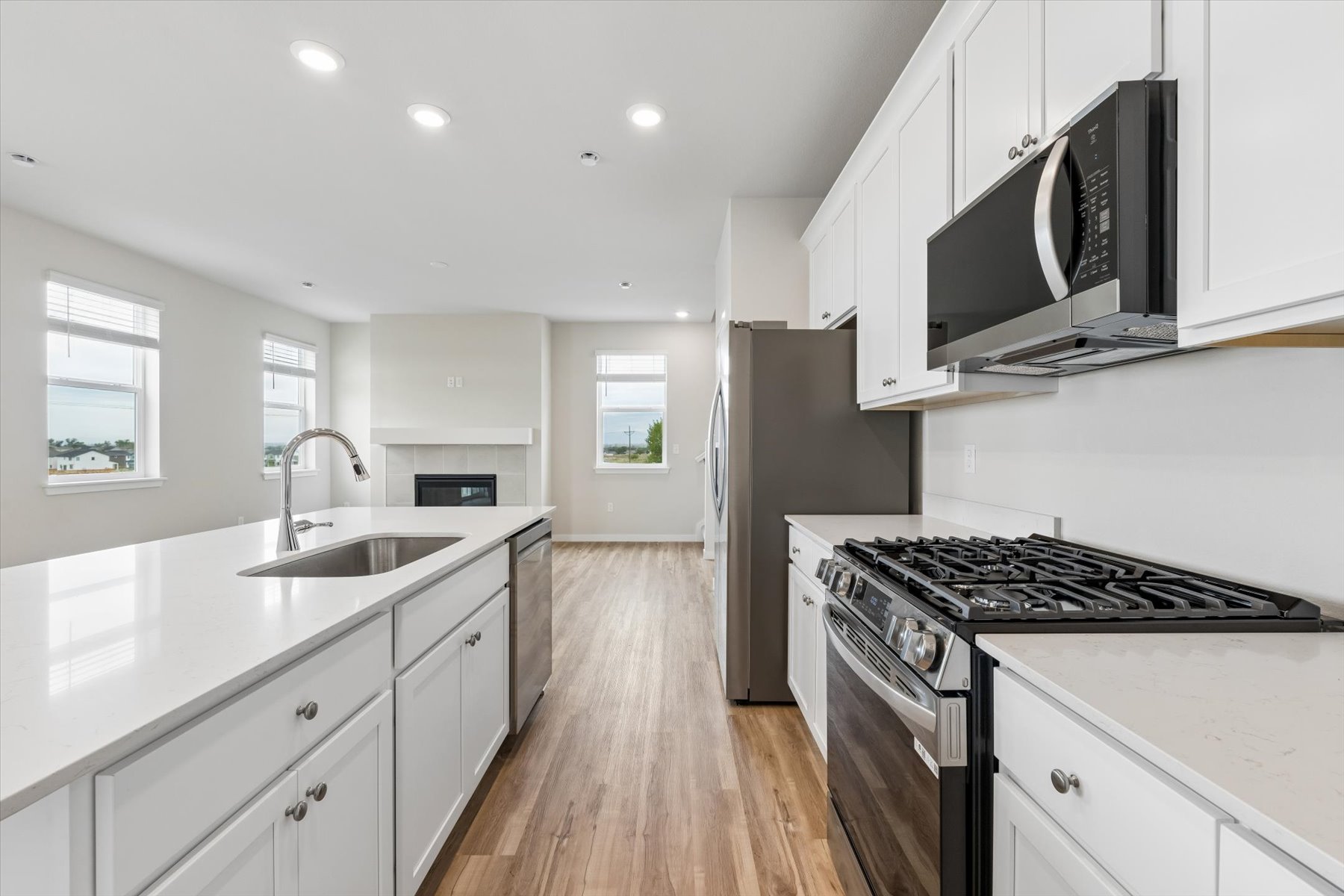 A kitchen with white cabinets.